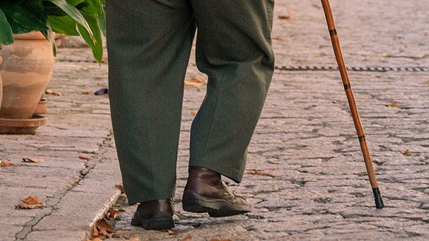 Older adult walking with a cane