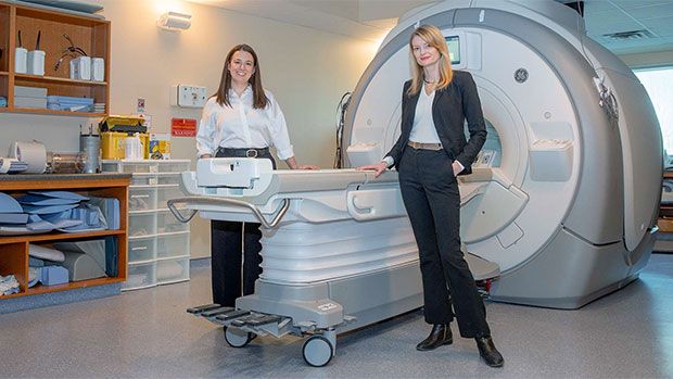 Researchers Emily Nichols (left) and Emma Duerden with the 3T MRI scanner at Western's Translational Imaging Research Facility. (Christopher Kindratsky / Western News)