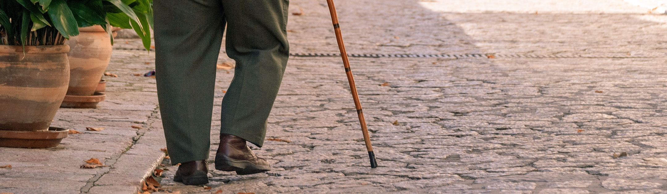 Older adult walking with a cane