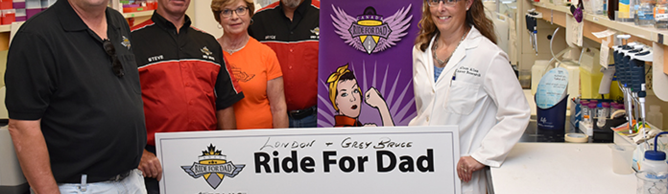 Representatives from Ride for Dad presenting a cheque to Dr. Alison Allan