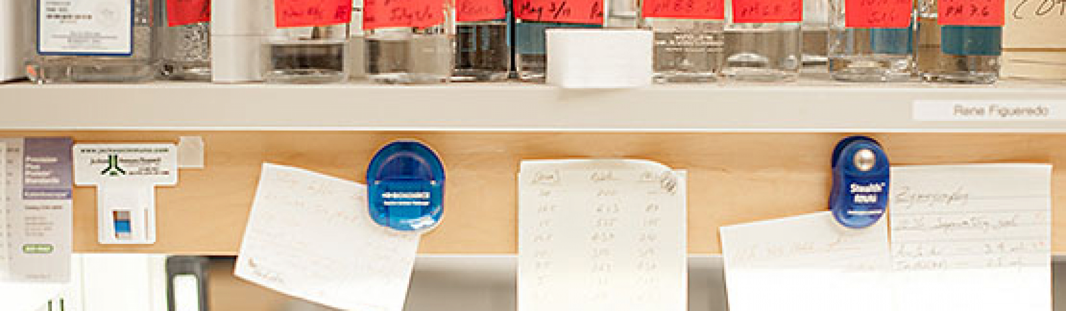 containers and papers on a shelf in a lab